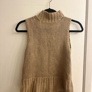 Sleeveless tan knit turtleneck sweater